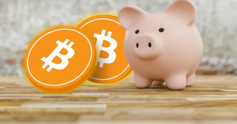 Bitcoin coins beside a pink piggy bank.