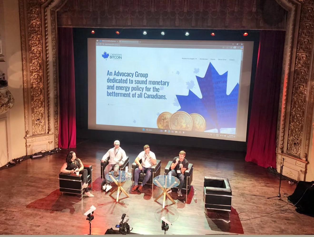 Panelists on stage at the Canadian Bitcoin Conference 2025 in Montreal, seated in front of a large screen promoting Bitcoin advocacy for Canada.