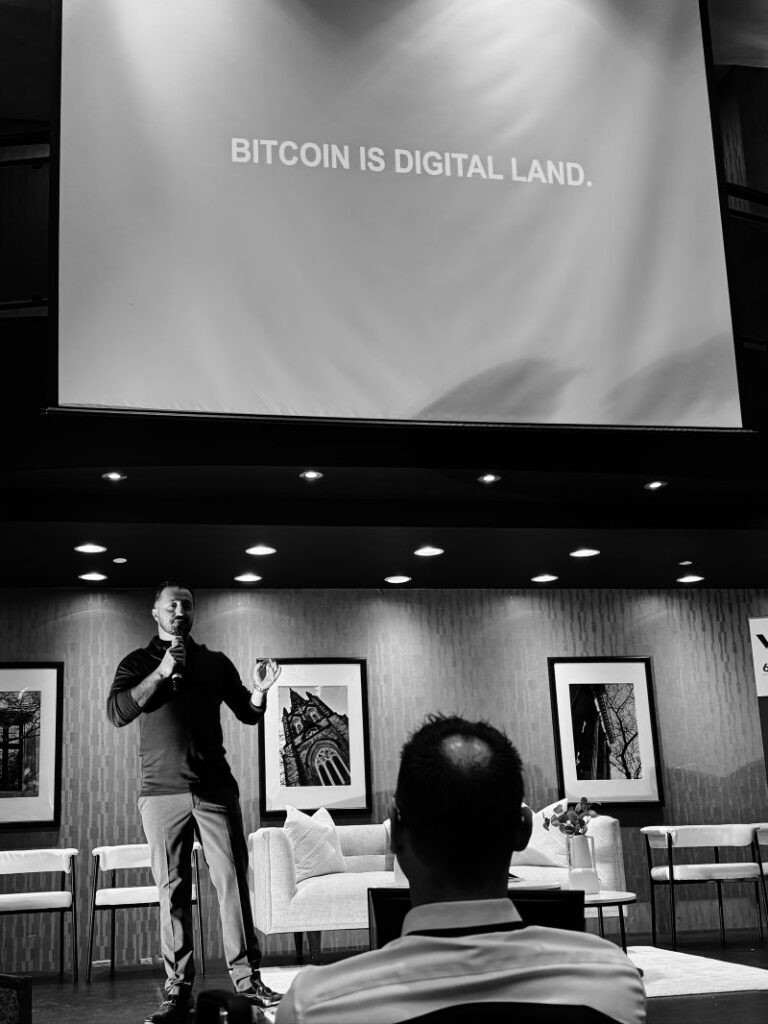 Speaker presenting about Bitcoin as digital land to an audience